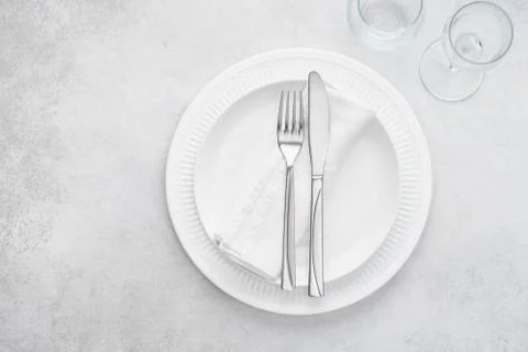 Restaurant table setting with white plates, glasses and cutlery. Stock Photos