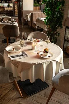 Restaurant table setup with candlelight and wine Stock Photos