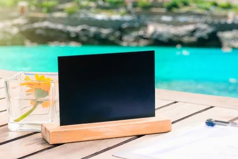 Restaurant table sign, Empty Restaurant black board on table at the Sea , moc Stock Photos