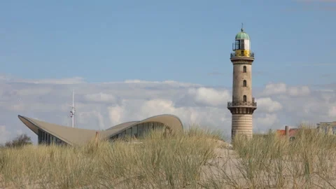 Restaurant Teepott and lighthouse in Warnemunde, Germany over sand dunes Stock Footage 111535117