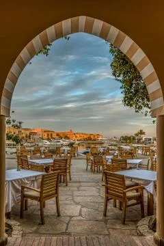 Restaurant under an arch in the  soft evening light Stock Photos