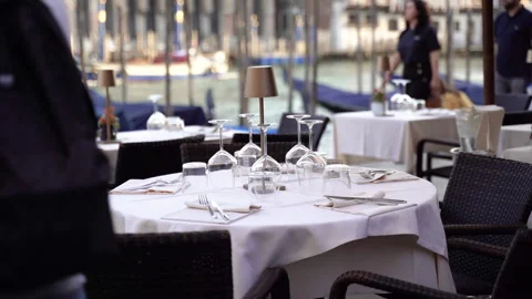 Restaurant with a Venetian canal in the background. Table setting in a street Stock Footage 289562928