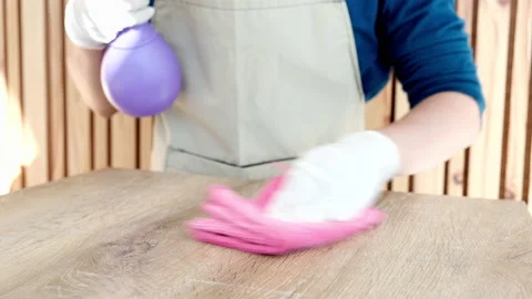 Restaurant worker is cleaning the dining table using a spray of alcohol and a Stock Footage 195449716