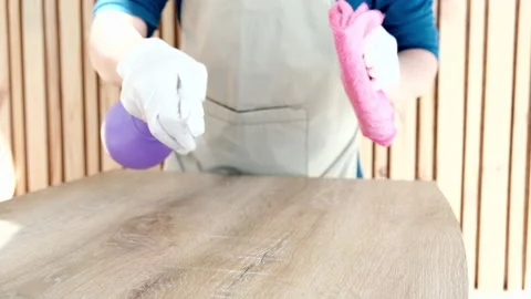 Restaurant worker is cleaning the dining table using a spray of alcohol and a Stock Footage 195449768