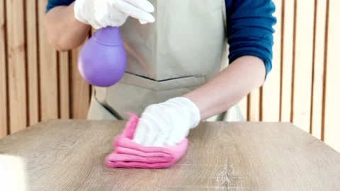 Restaurant worker is cleaning the dining table using a spray of alcohol Stock Footage 196220392