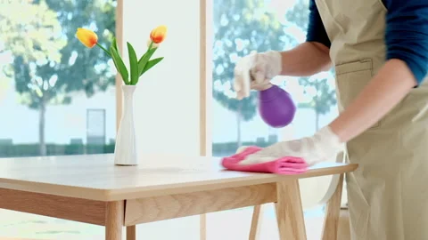 Restaurant worker is cleaning the dining table using a spray of alcohol and a Stock Footage 196220399