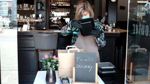 Restaurant worker giving paper bag with fresh packed food to a customer Stock Footage