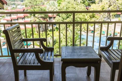 Resting area of balcony with two couch armchair sofa outdoor. high view. sun  Foto stock