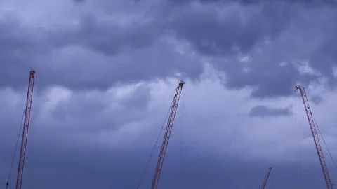 Resting construction tower cranes and cloudy sky Stock Footage 130169765