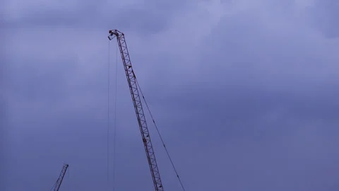 Resting construction tower cranes and cloudy sky Stock Footage 130172600