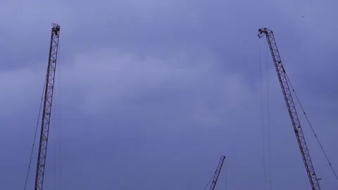 Resting construction tower cranes and cloudy sky Stock Footage 130173859