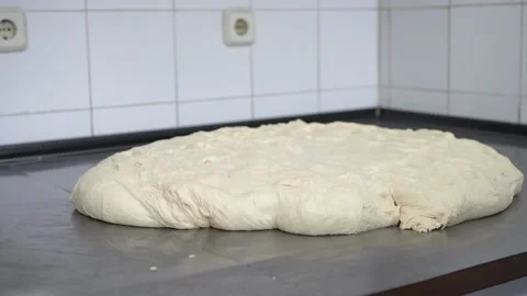 Resting the dough on a tabe in order for the gluten to loosen and unwind 스톡 동영상 251301560