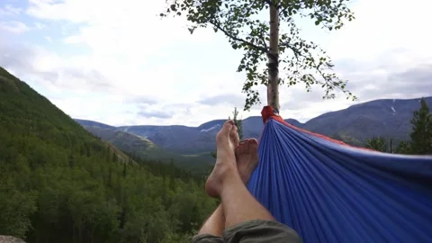 Resting in a hammock admiring the view of the mountains Stock Footage 228717102