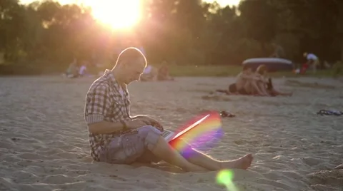 Resting Man at Sunset with a Laptop Stock Footage 57258009