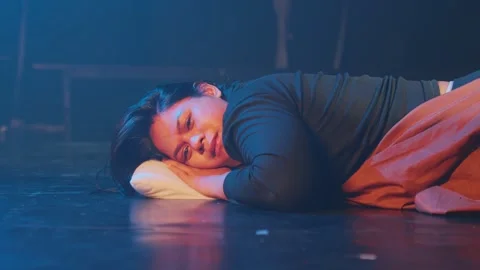 Resting Performer on Stage with Dramatic Lighting Stock Footage 296589097