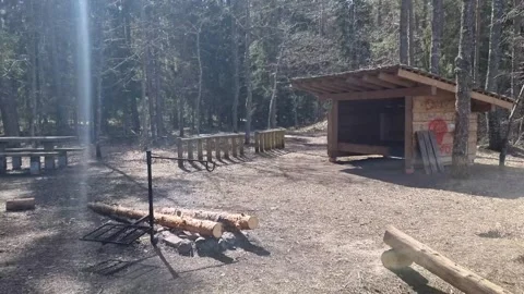 Resting place with a canopy and a campfire place by the river Gauja. Stock Footage 301225626