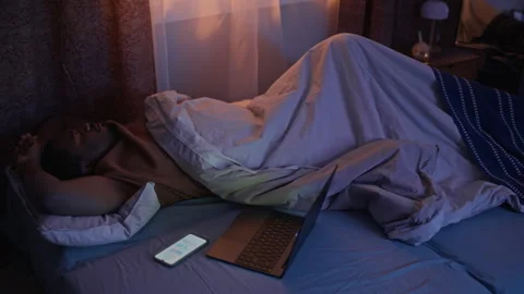 Restless Black Man Having Trouble Sleeping in Bed Beside Laptop Stock Footage 337723221