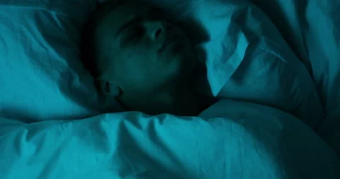 Restless man sleeping on bed Stock Footage 145293038