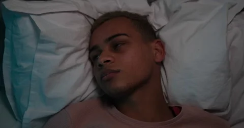 Restless man trying to sleep lying on bed Stock Footage 145295223