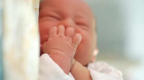 Restless sleep of a newborn kid. Small depth of field with focus on the hand Stock Footage 67210933
