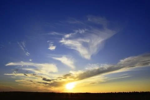 The restless sunset of the last spring day. Summer will come tomorrow. Stock Photos