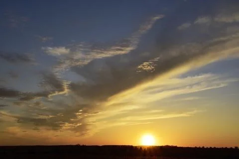 The restless sunset of the last spring day. Summer will come tomorrow. Stock Photos