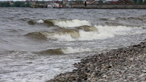 Restless Waves Crashing Against the Pebble Shore at the Volga River Harbor Stock Footage 346051703