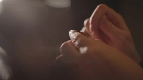 Restoration expert sewing under lighting. Expert performing intricate sewing Stock Footage 346550032