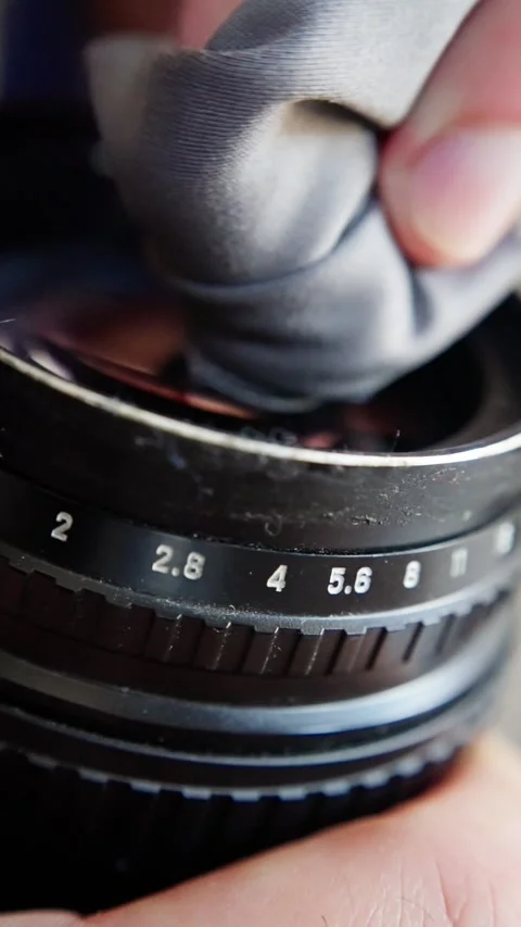 Restoration of old camera lens with microfiber cloth, hobbyist delicately wipes Stock Footage 321611894