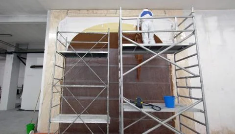 Restoration worker on a scaffold Stock Photos