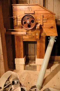 Restored grain elevator, and milling equipment in historic watermill Stock Photos