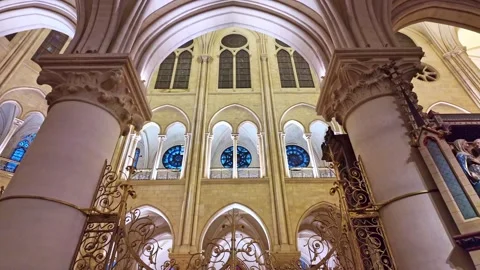 Restored interior of Notre-Dame Cathedral with stained glass, France. Tilt-down Stock Footage 303413332