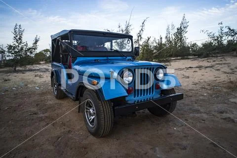 Restored retro car during the American Vietnam war on the sand in the desert Stock Photos