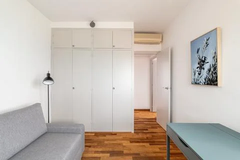 Restored room with wardrobe sofa and table in apartment Stock Photos