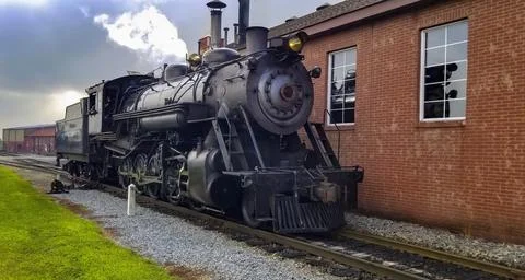 Restored Steam Engine Getting Ready for Service, Blowing Smoke and Steam Stock Photos