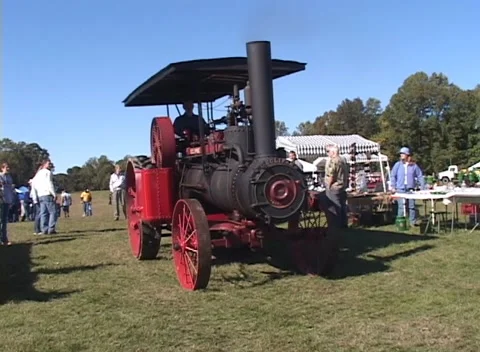 Restored Steam Tractor running across a field Stock Footage 141166341
