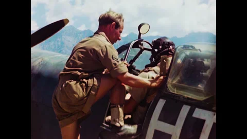 Restored WWII Ground Crew Buckling In Spitfire Pilot, Corsica 1944, 60FPS Stock Footage 336780896