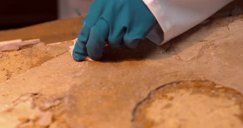 The restorer introduces the adhesive solution with a syringe into the cracks  Stock Footage 119548083