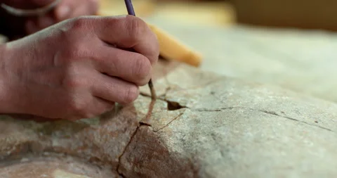 The restorer introduces the cement mortar by a small brush into the cracks Stock Footage 119547811