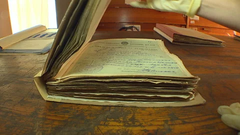 Restorers restore old archival documents, books and photographs. Stock Footage 101204068