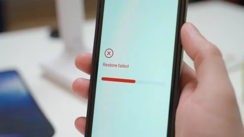 Restoring from backup progress on smartphone screen ends with restore failed Stock Footage 342602731