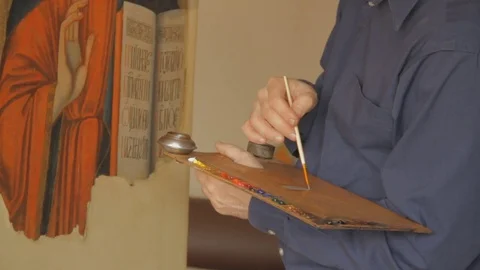 Restoring the Icon of Orthodox Saint Repairing and Restoring the Old Icons Stock Footage 71551952
