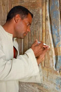 Restoring painted bas relief at Medinet Habu Temple, Luxor Stock Photos