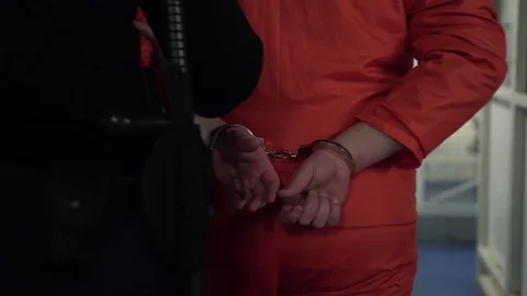 Restrained Prisoner In Handcuffs Walking With Prison Guard,  Orange Jumpsuit Stock Footage