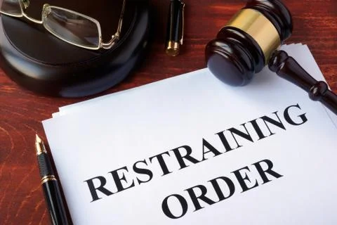 Restraining order and gavel on a table. Stock Photos