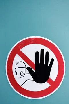 Restricted Access Warning Sign with Black Stop Hand on Turquoise Wall 스톡 사진