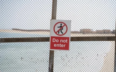 Restricted area with do not enter sign. No entry Photos