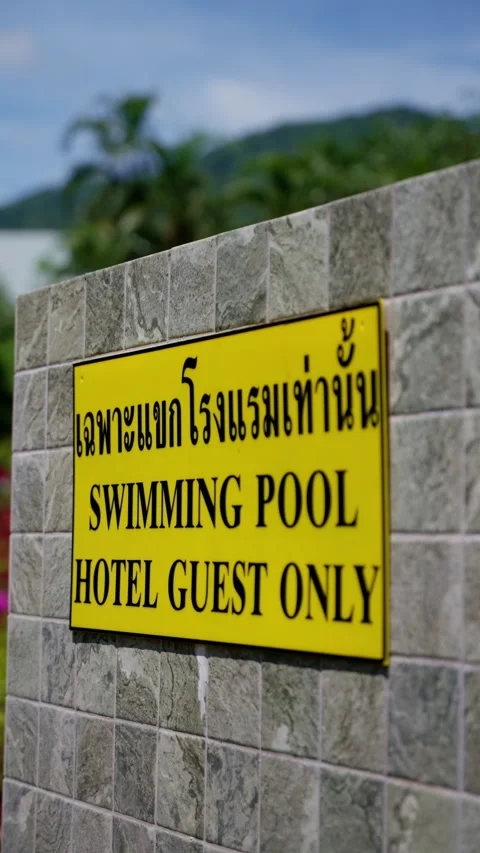 Restricted hotel swimming pool warning sign displaying yellow restrictive Video stock 308577828