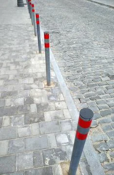 Restrictive posts between the pedestrian sidewalk and the road Stock Photos
