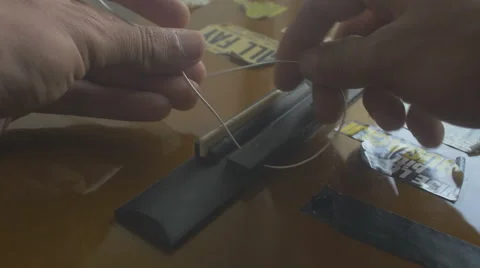 Restringing Your Classical Guitar [close up] bridge Stock Footage 68038228